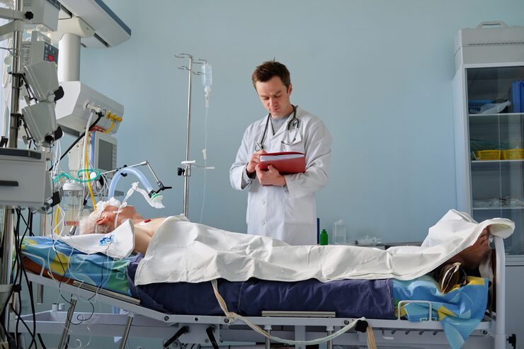 intensive care caucasian doctor examines intubated critical stance patient writing notes case report intensive care department 133994 1314